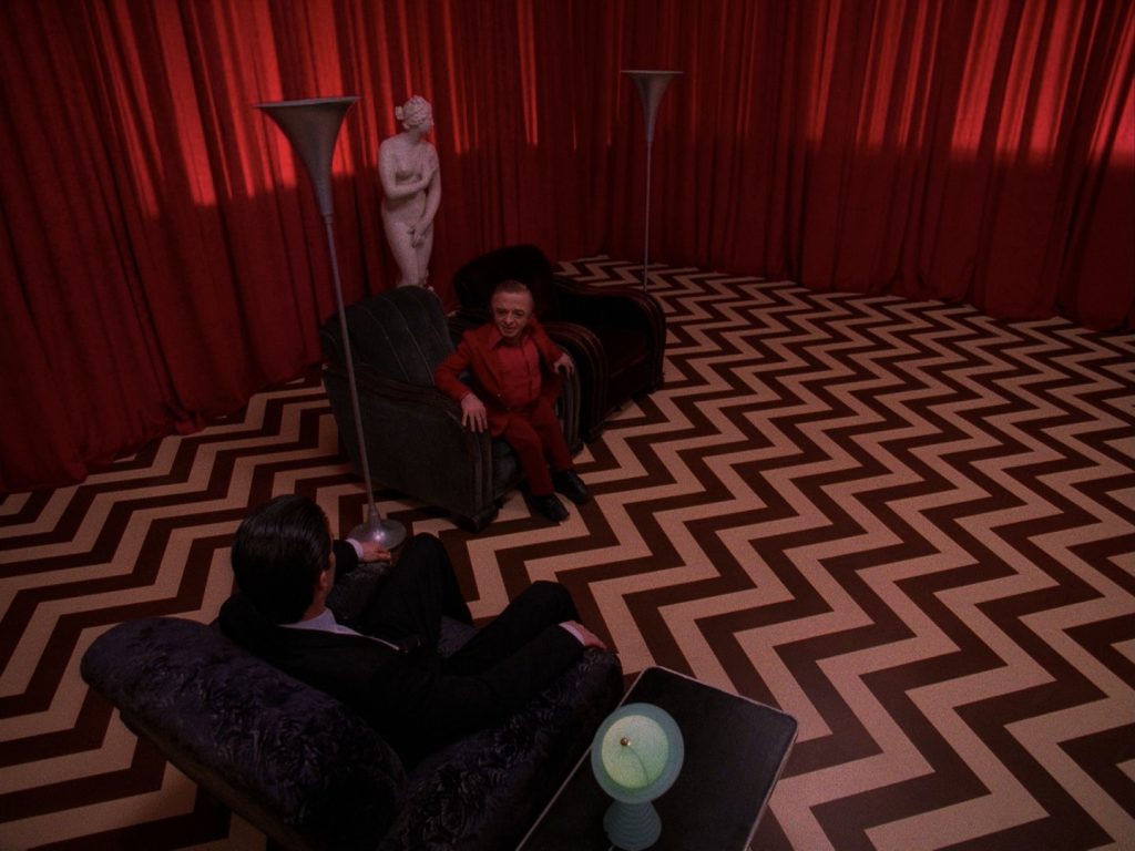 Agent Cooper sitting in the Red Room with The Little Man From Another Place