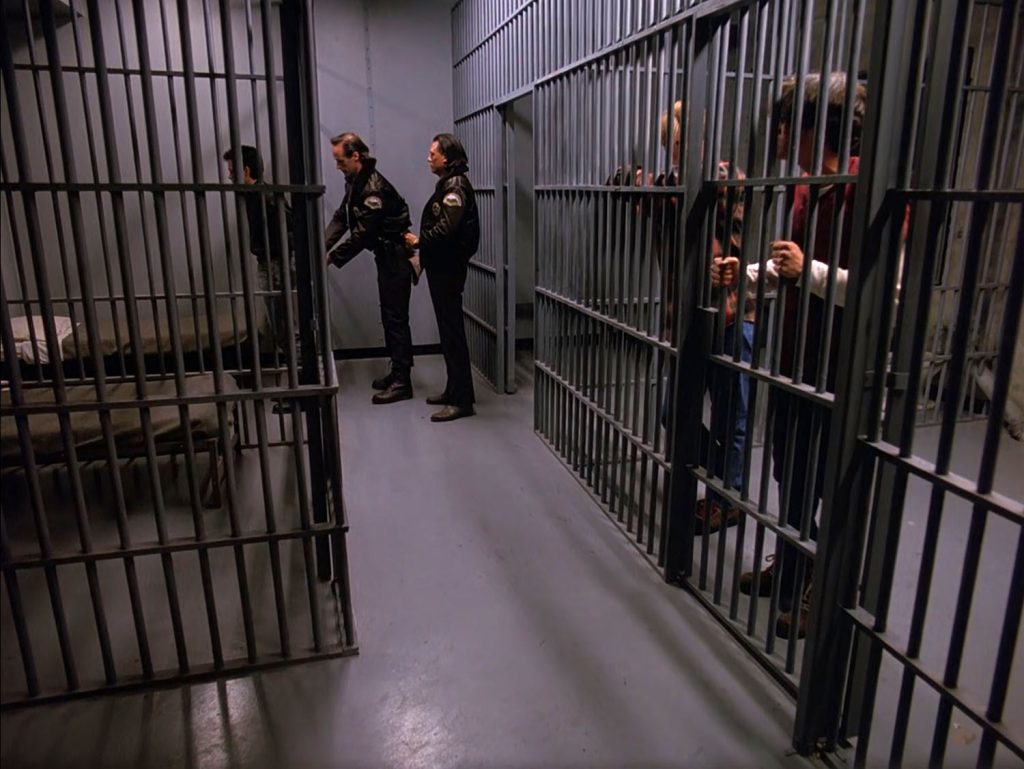 Deputy Andy unlocking James Hurley's handcuffs