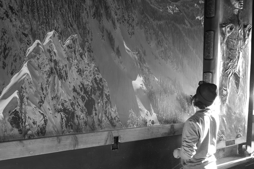Scott Rinckenberger installing the mural