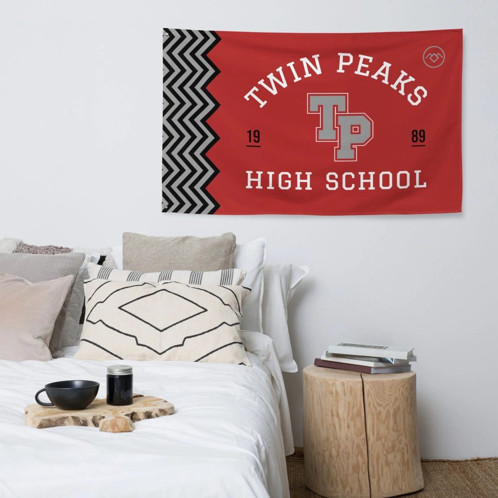 Twin Peaks High School flag hanging on a wall in a room