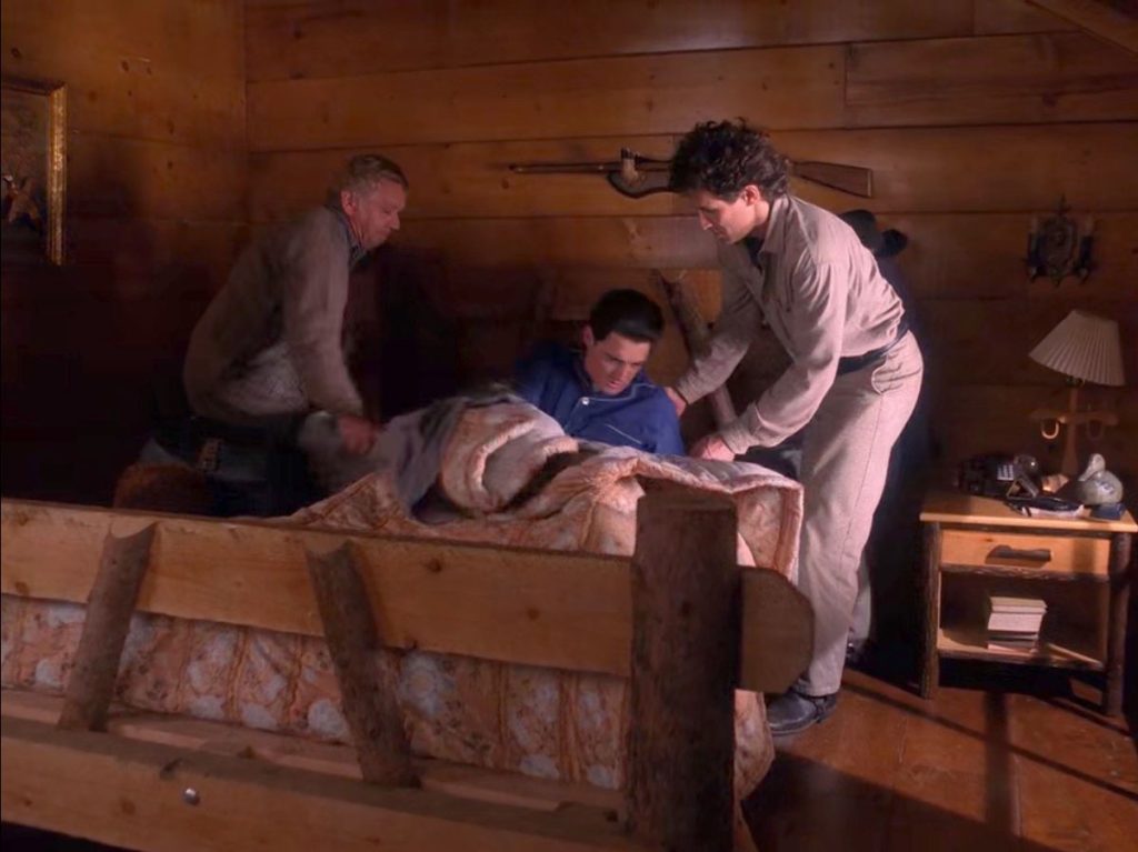 Doc Hayward and Sheriff Truman help Cooper out of his bed