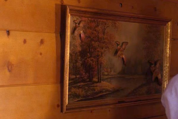 Artwork hanging on a wooden wall