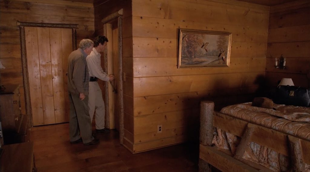 Doc Hayward and Sheriff Truman by the bathroom door in Cooper's room