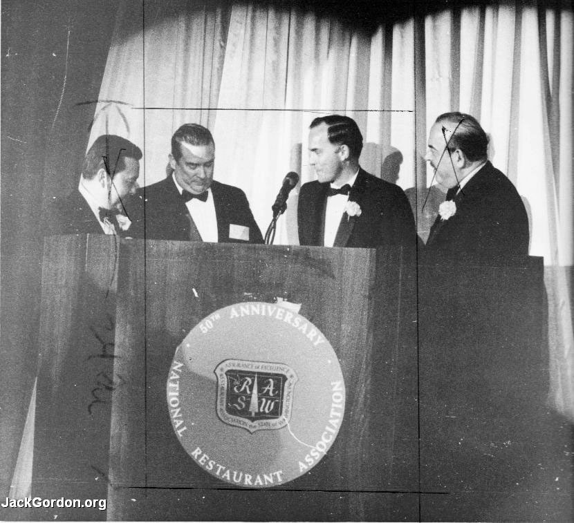 Four men at a podium