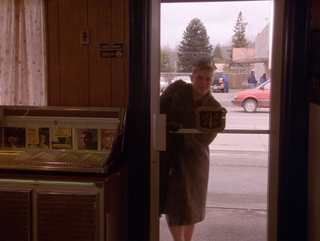 Heidi entering the front door of the Double R Diner