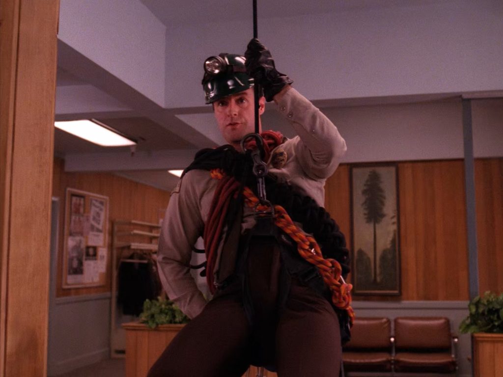 Andy suspended by rope in the lobby