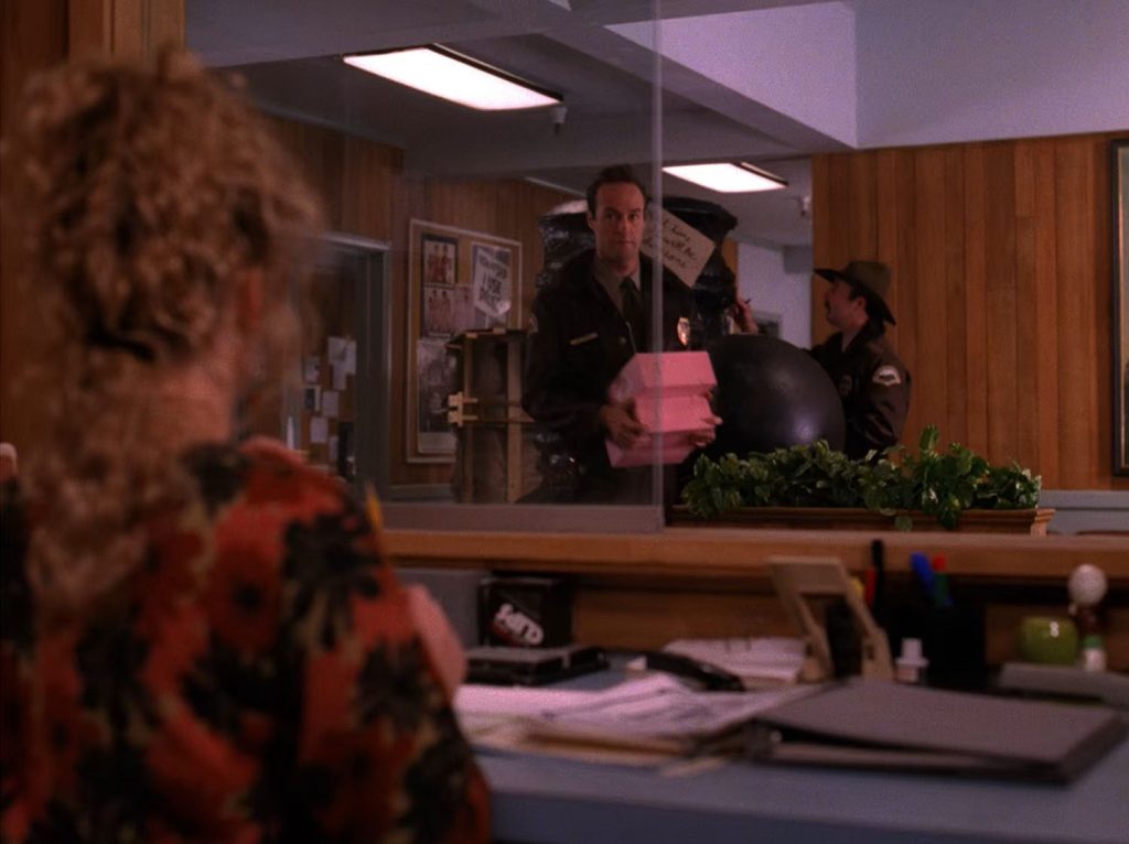 Andy speaks with Lucy while holding doughnut boxes