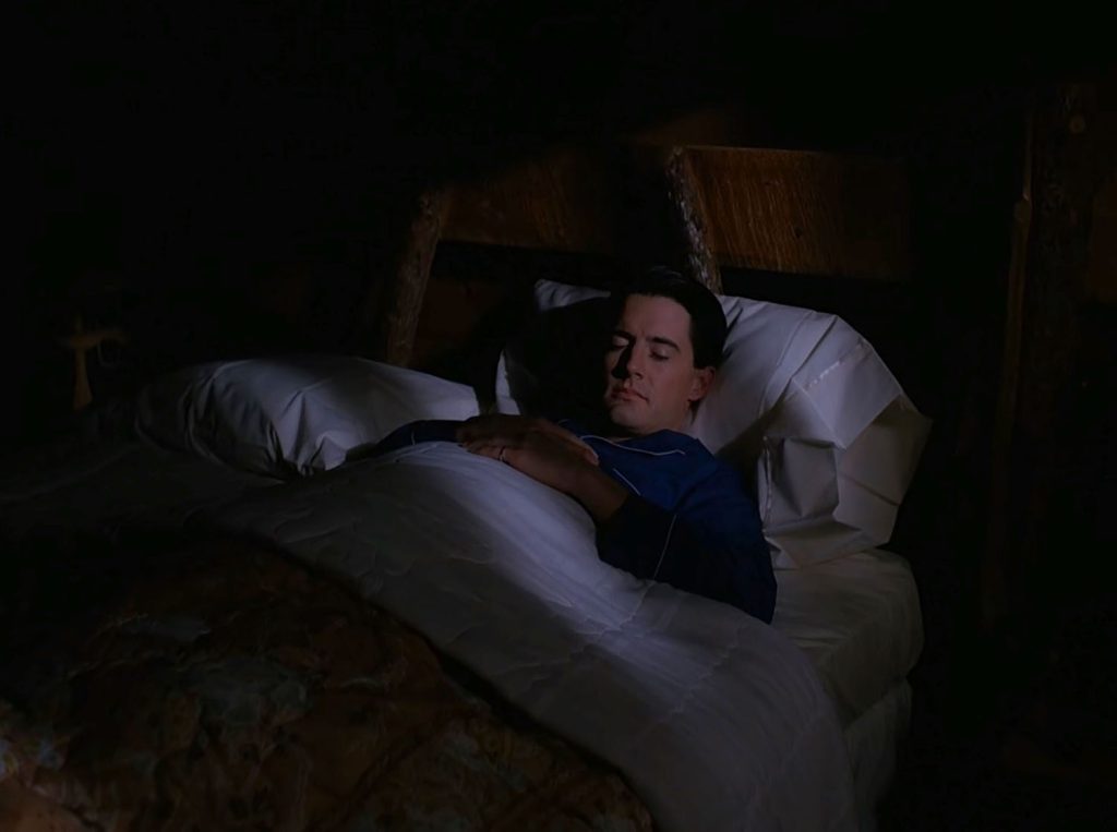 Special Agent Dale Cooper sleeping in his bed.