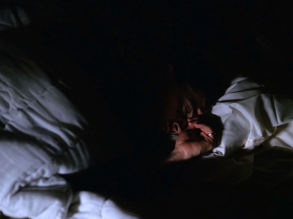 Special Agent Dale Cooper sleeping in his bed.