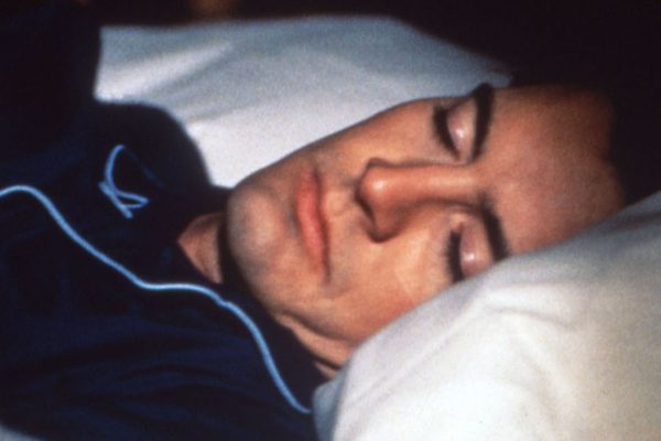 Special Agent Dale Cooper sleeping in his bed.