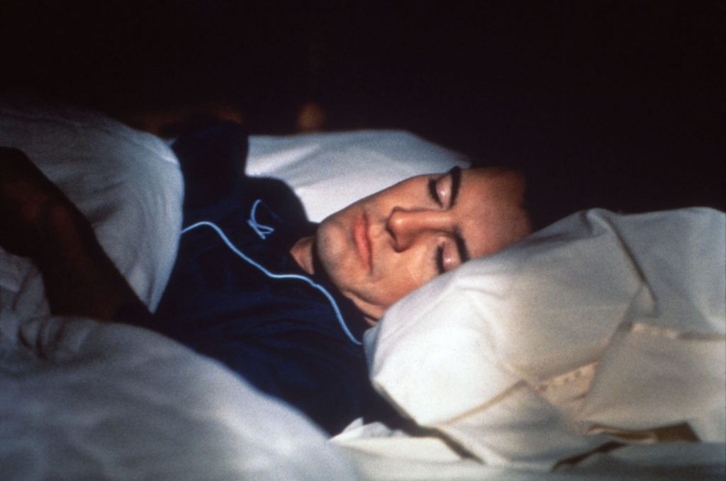 Special Agent Dale Cooper sleeping in his bed.