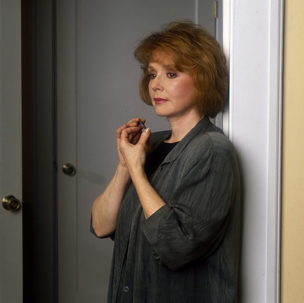 Piper Laurie playing Catherine Martell holding a One-Eyed Jacks Poker Chip