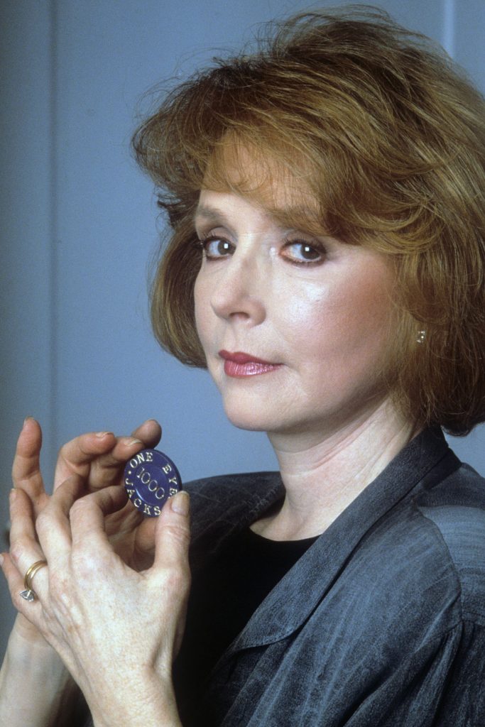 Piper Laurie playing Catherine Martell holding a One-Eyed Jacks Poker Chip