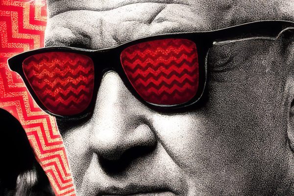 David Lynch wearing glassed with chevron pattern in reflection
