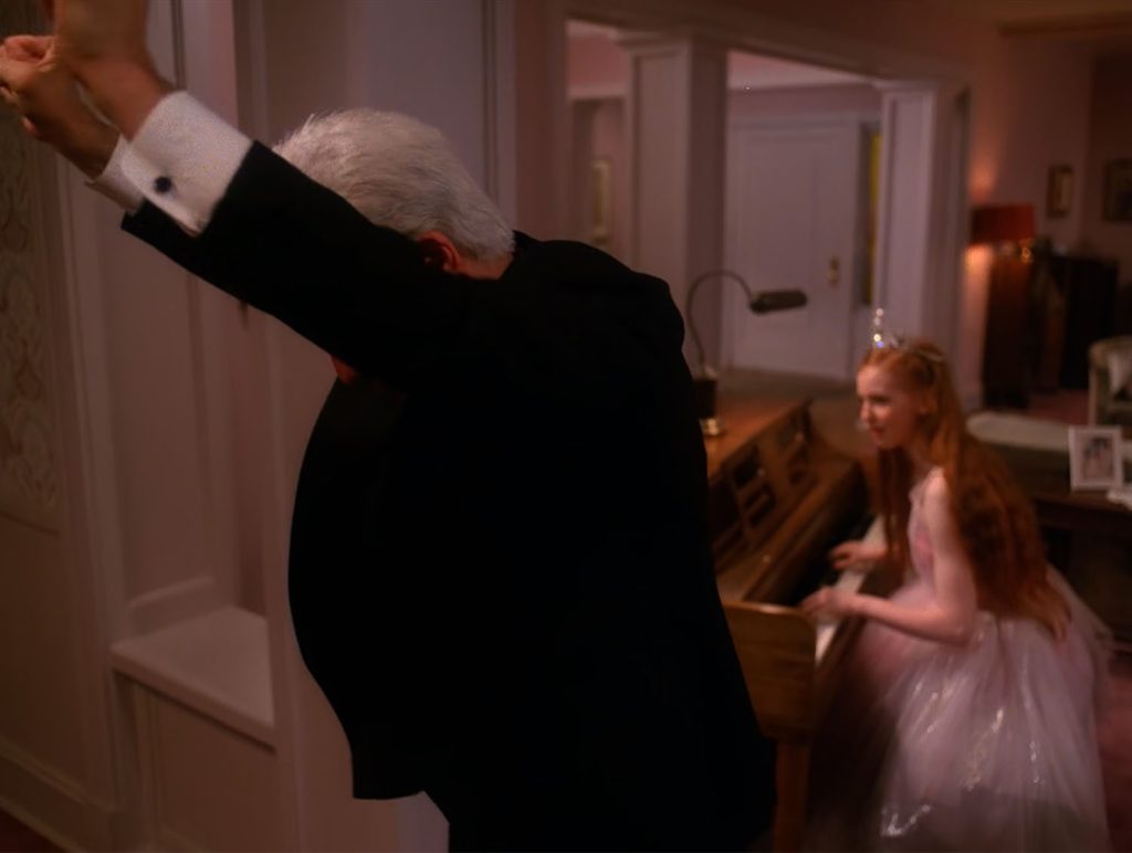 Leland Palmer raising his arms with Gersten Hayward at the piano