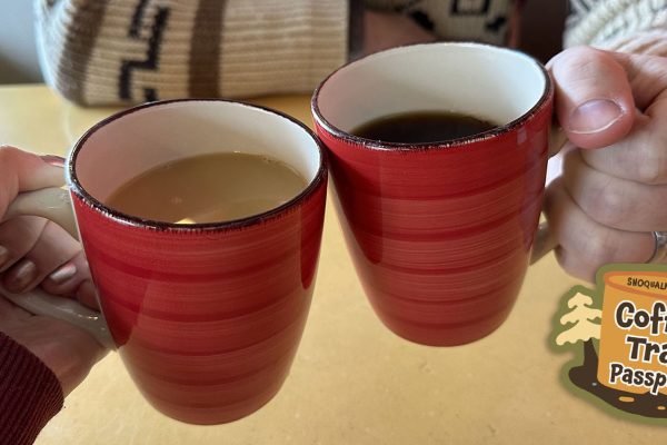 Two people holding cups of coffee at Twede's Cafe