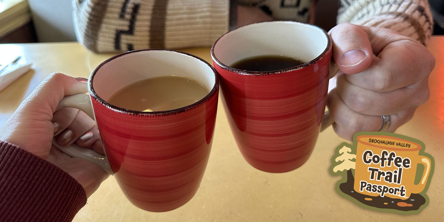 Two people holding cups of coffee at Twede's Cafe