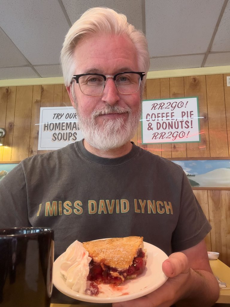 Steven holding cherry pie and coffee at Twede's Cafe