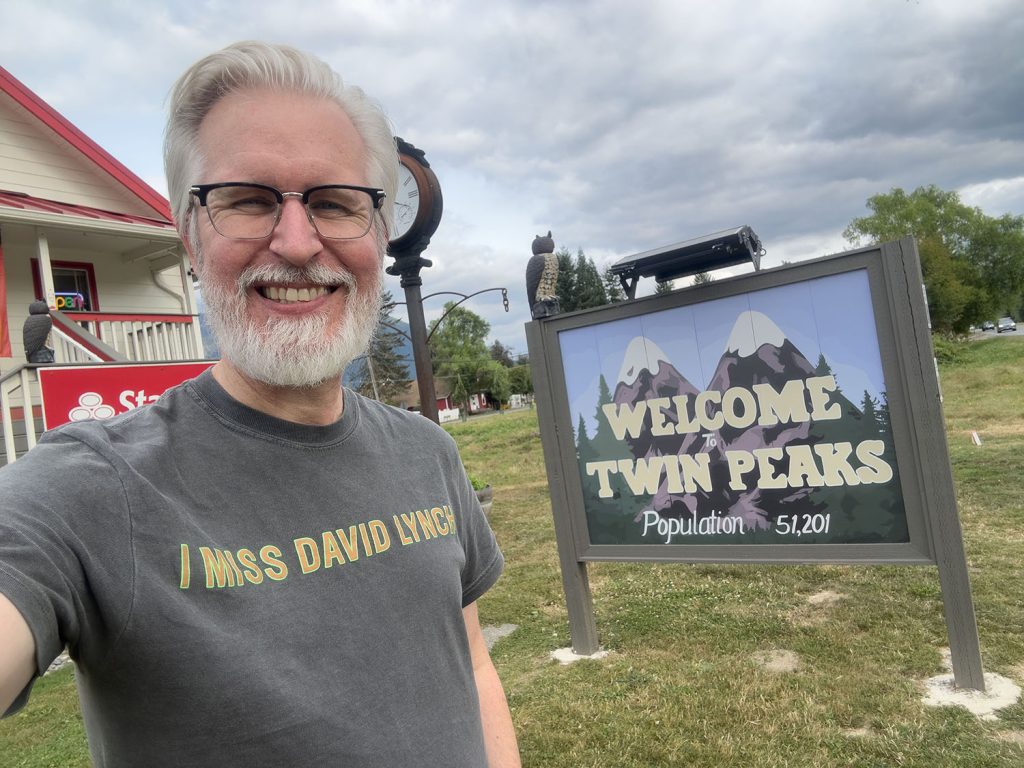 Steven by the Welcome to Twin Peaks sign in Snoqualmie, WA