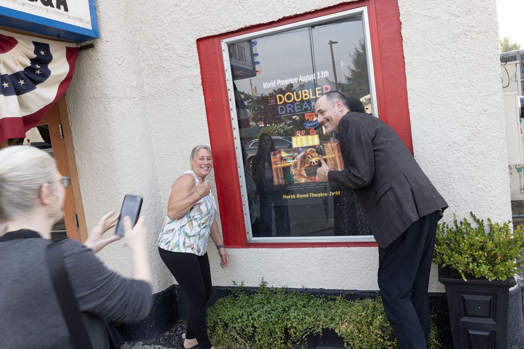 Jen taking a photo of Anita and Scott
