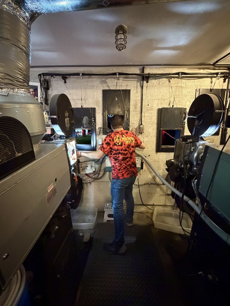 Projectionist Robert Humanick in booth at Mahoning Drive-In