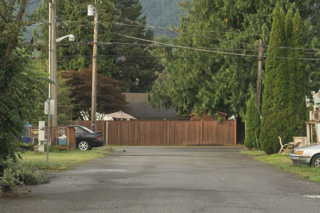 Brown fence across the road from the Towne Mobile Home Park
