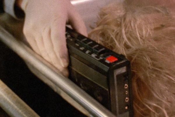 Special Agent Sam Stanley placing a tape recorder by Teresa Banks' head