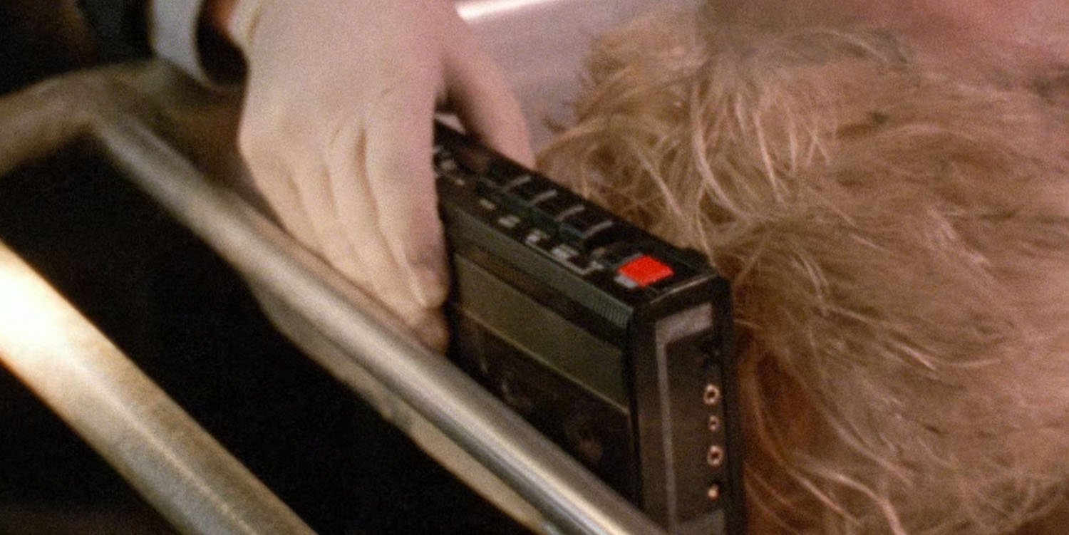 Special Agent Sam Stanley placing a tape recorder by Teresa Banks' head