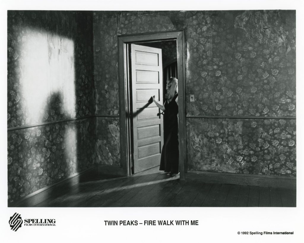 Black and white photo of Laura Palmer standing at the doorway from Twin Peaks: Fire Walk With Me