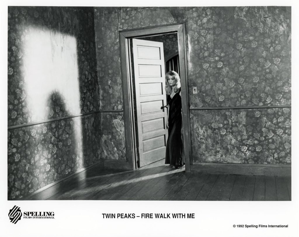 Black and white photo of Laura Palmer standing at the doorway from Twin Peaks: Fire Walk With Me