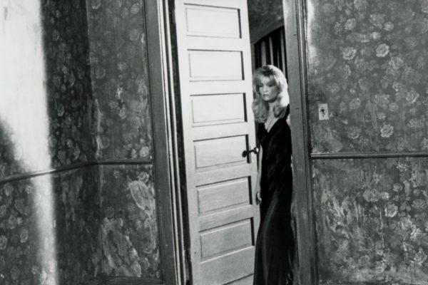Black and white photo of Laura Palmer standing at the doorway from Twin Peaks: Fire Walk With Me