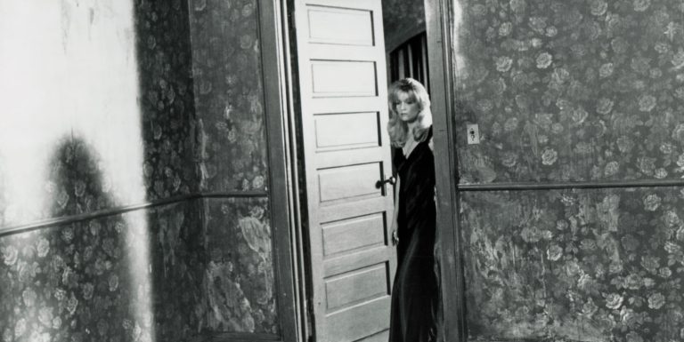 Black and white photo of Laura Palmer standing at the doorway from Twin Peaks: Fire Walk With Me