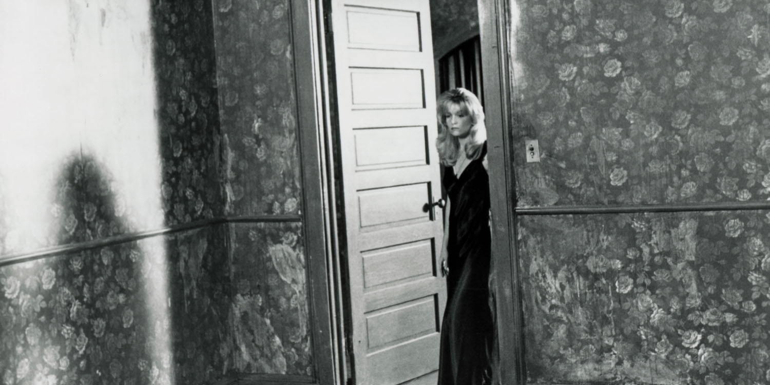 Black and white photo of Laura Palmer standing at the doorway from Twin Peaks: Fire Walk With Me
