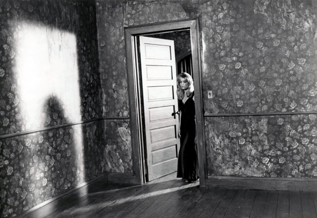 Black and white photo of Laura Palmer standing at the doorway from Twin Peaks: Fire Walk With Me