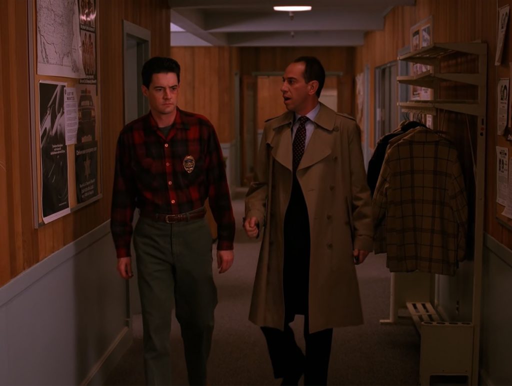 Agents Cooper and Rosenfield walking through the Sheriff's Department with an anti-drug poster