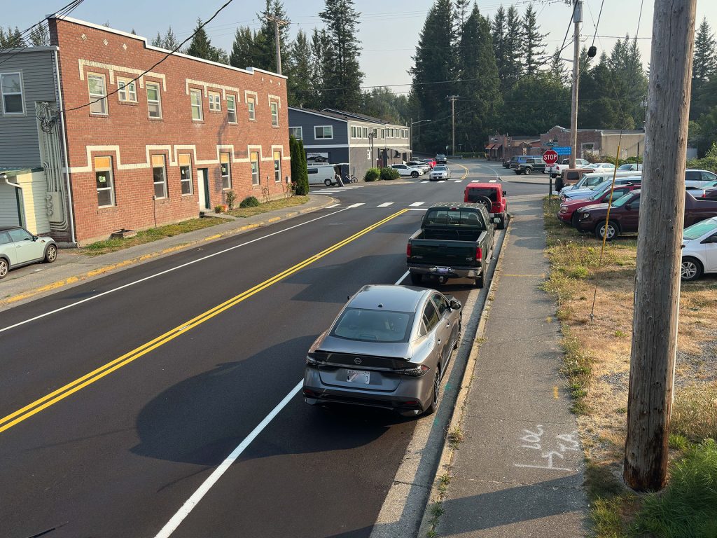 Road in Meadowbrook lined with cars