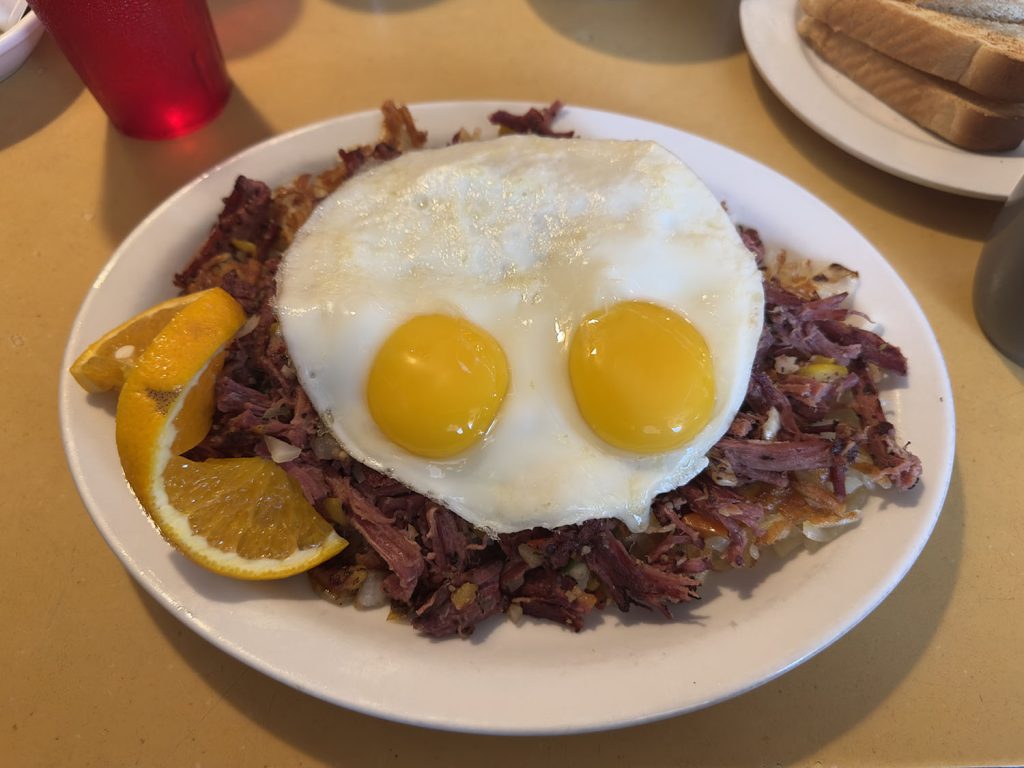 Plate of corned beef hash with two eggs