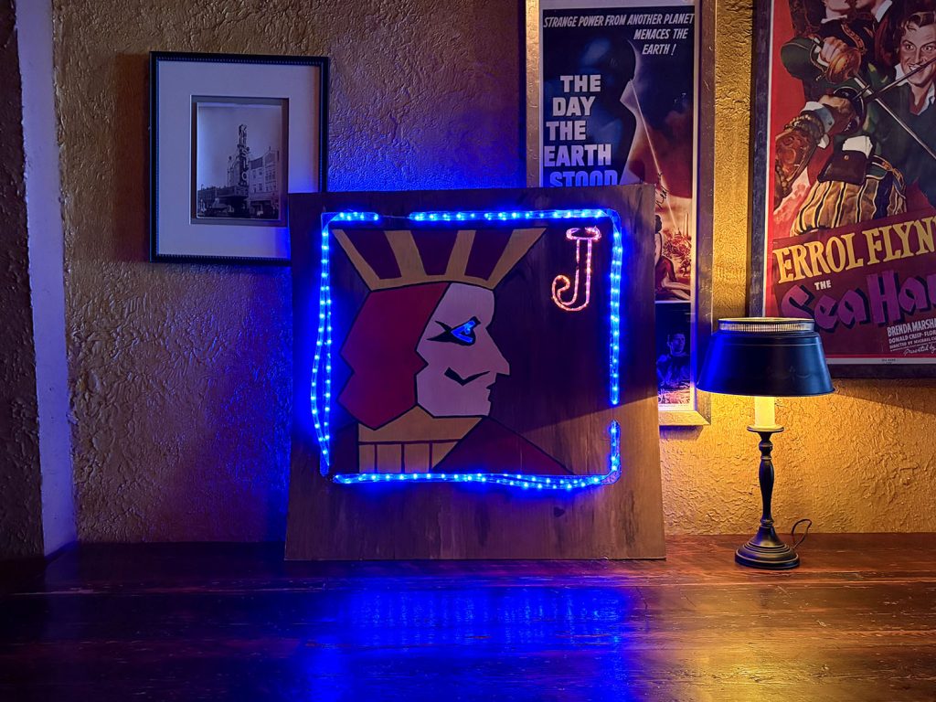 A light up One Eyed Jacks sign on a counter