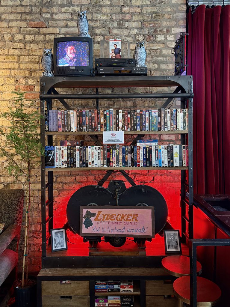 TV stand and display with video tapes and a Lydecker Animal Clinic sign