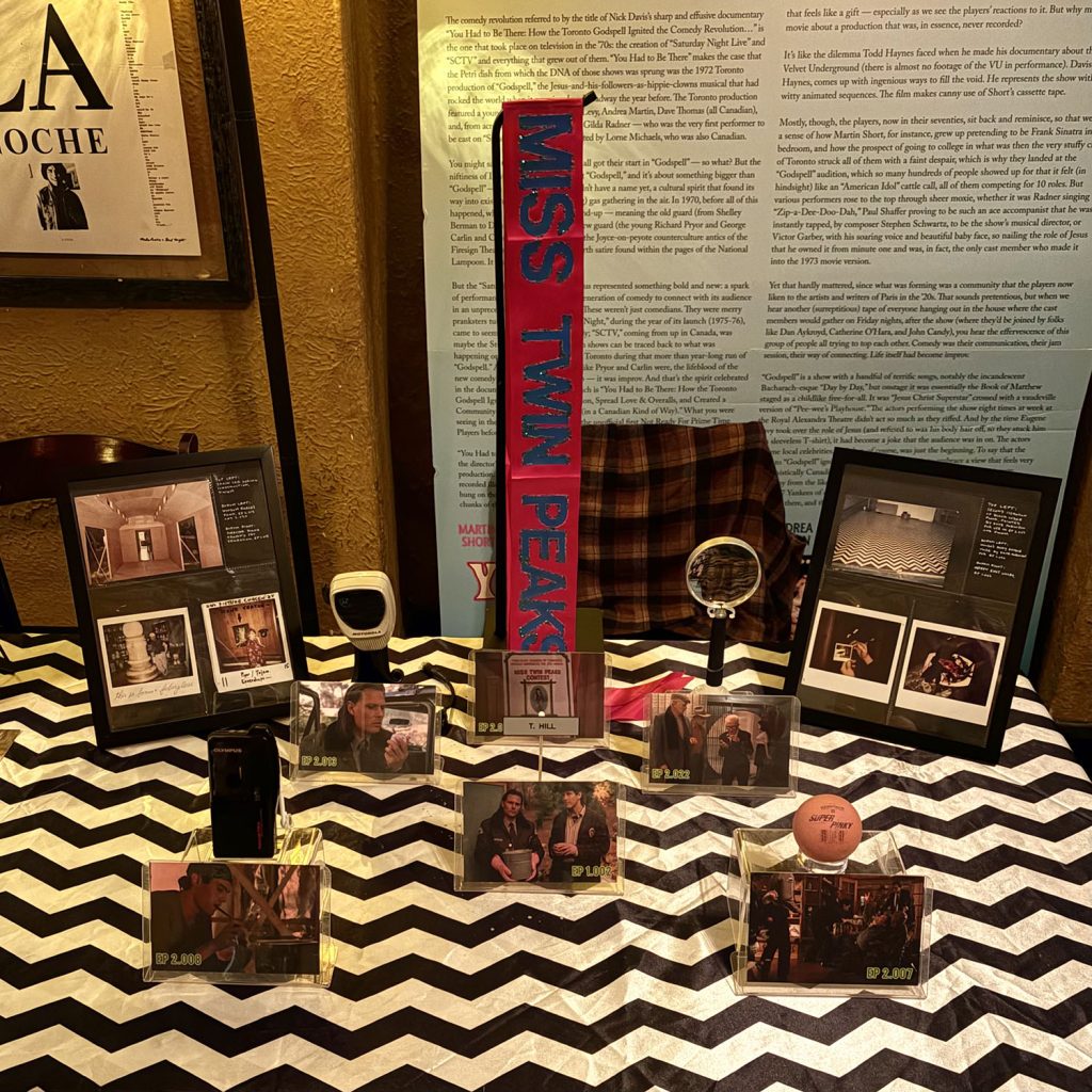 Table with chevron pattern table cover and adorned with Twin Peaks props