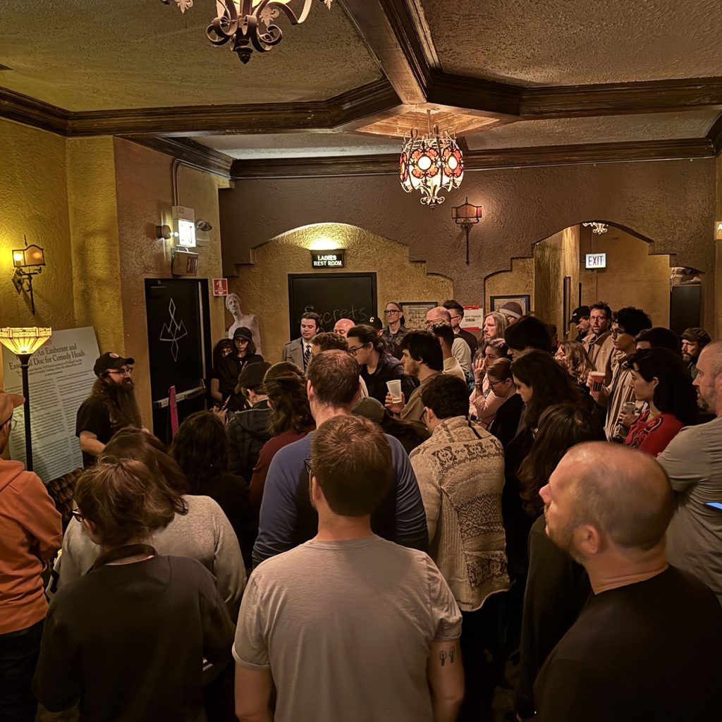 Vinnie Guidera speaking with guests in theatre lobby
