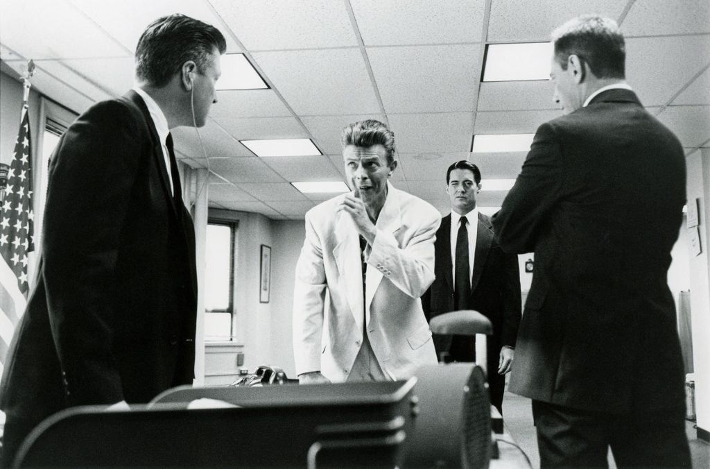 Black and white photo of Phillip Jeffries speaks with Gordon Cole, Dale Cooper and Albert Rosenfield