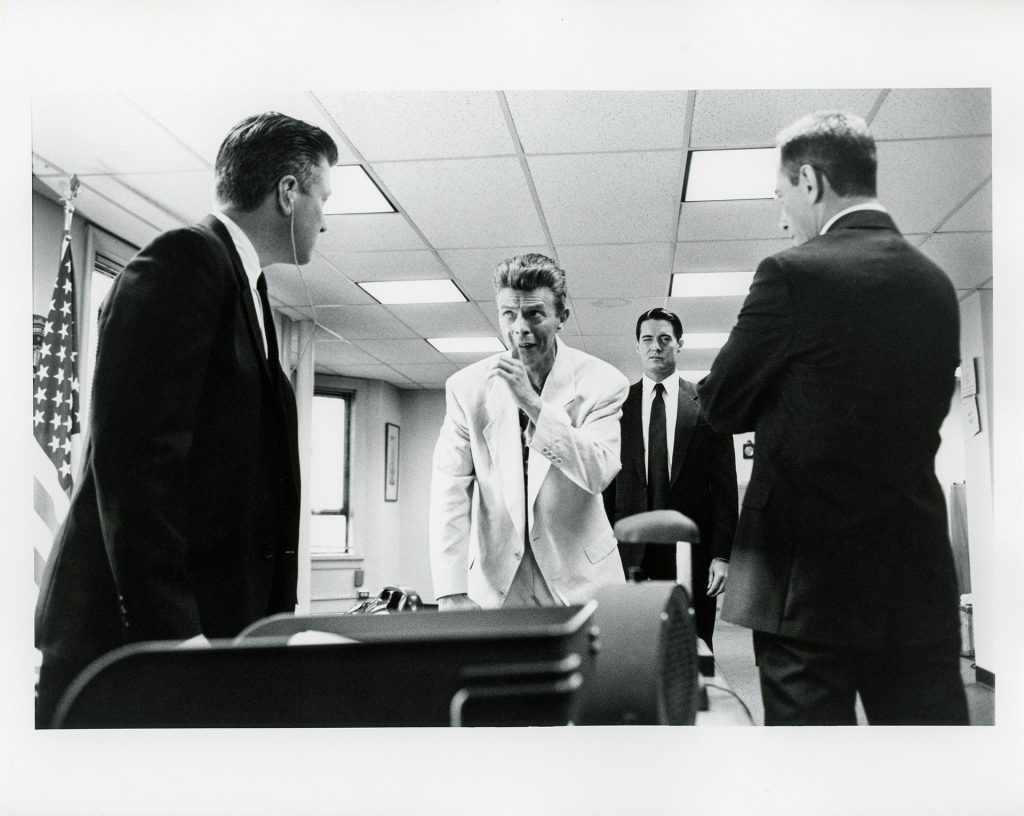 Black and white photo of Phillip Jeffries speaks with Gordon Cole, Dale Cooper and Albert Rosenfield