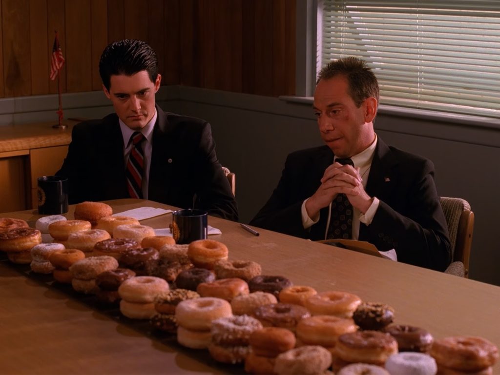 Special Agent Cooper and Albert Rosenfield sitting at a table with doughnuts