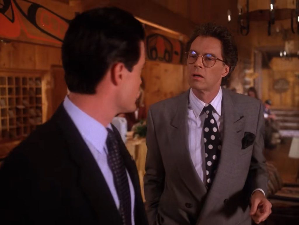 Special Agent Dale Cooper and Ben Horne speaking near the front desk