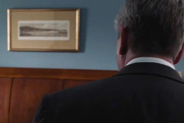 Detective Mackley and a framed art piece