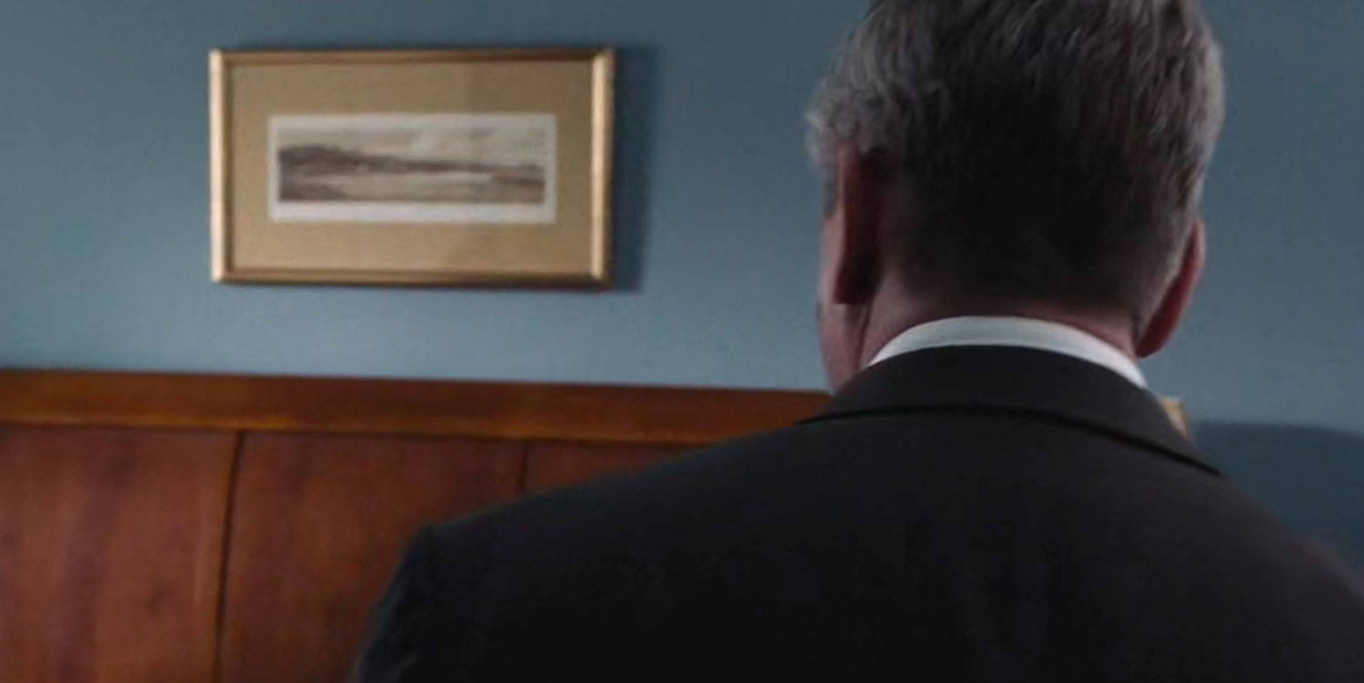Detective Mackley and a framed art piece