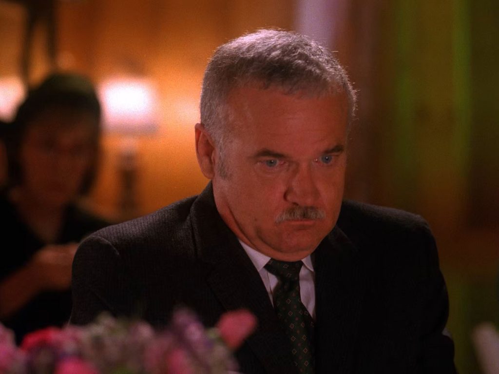 Pete Martell at a table with the Log Lady in the background