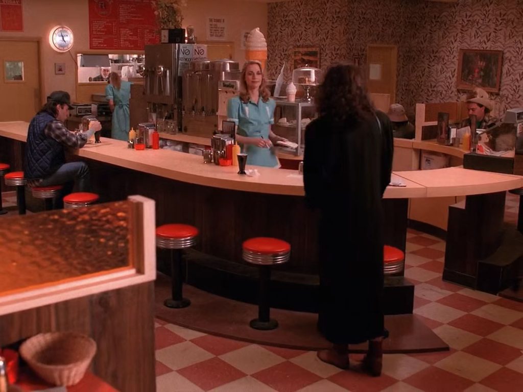 Maddy at the Double R Diner counter speaking with Norma Jennings