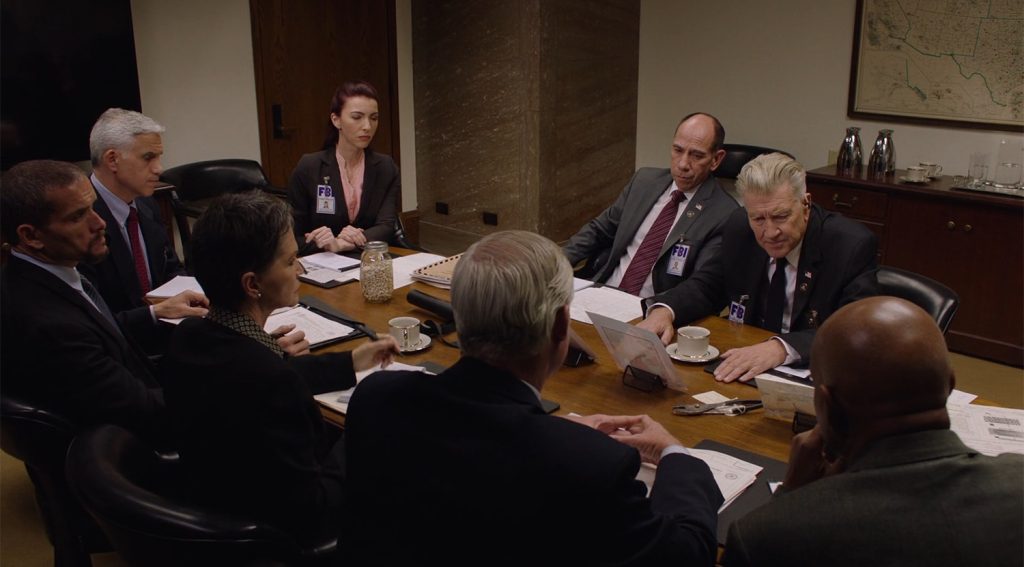 FBI Agents gathered around a conference room table